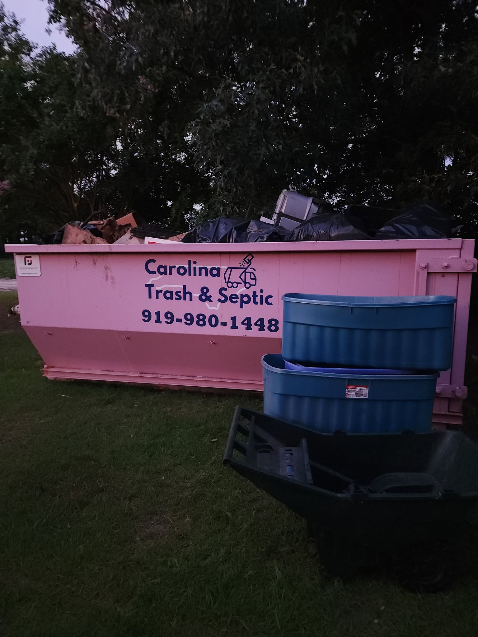 Estate cleanout in progress with a full removal container